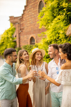 Group Of Happy Young People Cheering With Fresh Lemonade In The Garden