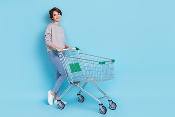 Full body photo of short hairdo young lady do shopping wear shirt jeans shoes isolated on blue...