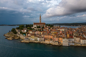Fototapeta na wymiar St. Euphemia church bell tower dominating the town of Rovinj surrounded by sea.