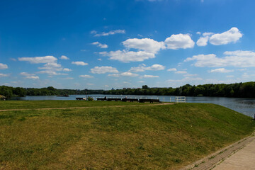Green lawn with benches overlooking the river