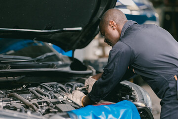 mechanic male car engine service underhood checking oil replace in broken part at auto garage