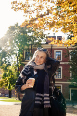 Portrait of a beautiful well-groomed elderly lady in an autumn park