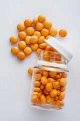 orange valerian pills on a white acrylic background