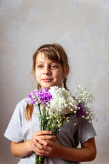 Portrait of 10 years old  girl  with a bouquet of flowers