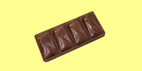 Chocolate bar isolated on a yellow background. Milk chocolate