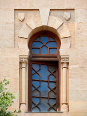 Fototapeta premium Horseshoe shaped window in stone wall