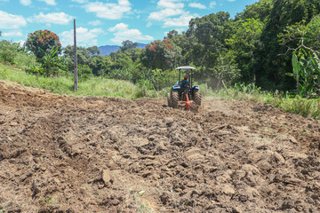 Farmer on tractor with plow preparing land for planting