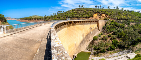Dried up riverbed of river Ribeira de Odiáxere in front of the footbridge over the dam of Algarve...