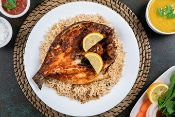 Arabian Sheri fish mandi rice with lemon slice served in dish top view of middle east food