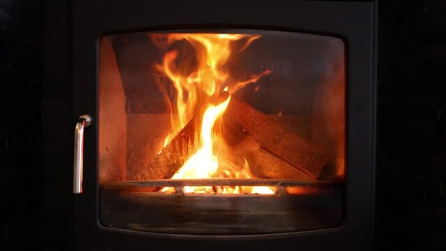 Logs on fire burning in a wood burner, slow motion
