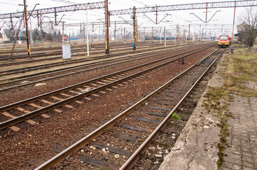 Fototapeta na wymiar Railway infrastructure, tracks, rails and power cables over the tracks. Day.