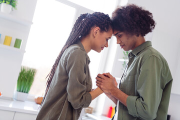 Photo of adorable couple touching foreheads touching hands express their emotions to each other