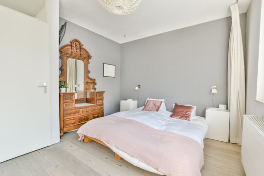 Soft bed and nightstand in modern light bedroom