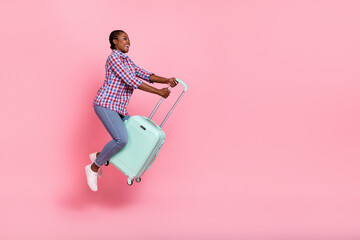 Full body profile photo of cheerful carefree lady flight suitcase look empty space isolated on pink...