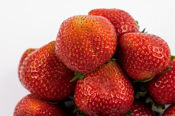 Ripe and juicy red strawberries on white background.