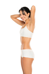 Fototapeta premium Young smiling woman in white underwear, posing in the studio on white