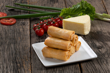 Fried spring rolls with sweet chili sauce and lime on plate