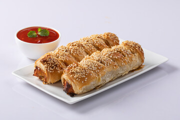 Chicken roll isolated on white with sauce 