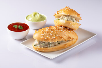 Fresh submarine sandwiches with ham, cheese, bacon, tomatoes, lettuce, cucumbers and onions on White background.