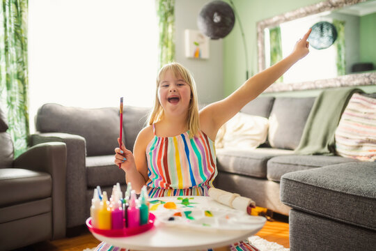 child girl having great time on living room painting great thing