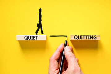 Quiet quitting symbol. Concept words Quiet quitting on wooden blocks. Beautiful yellow table yellow background. Businessman hand. Businesswoman icon. Business and quiet quitting concept. Copy space. - obrazy, fototapety, plakaty