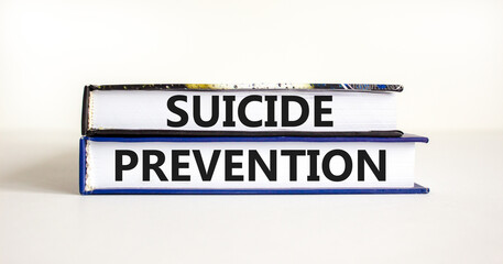 Suicide prevention symbol. Concept words Suicide prevention on books. Beautiful white table white background. Psychological and suicide prevention concept. Copy space.