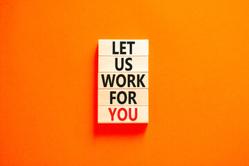 Let us work for you symbol. Concept words Let us work for you on wooden blocks. Beautiful orange table orange background. Business and let us work for you concept. Copy space.