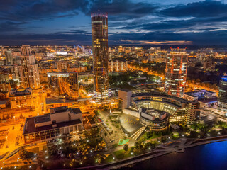 Fototapeta na wymiar Yekaterinburg city and pond aerial panoramic view at summer or early autumn night. Night city in the early autumn or summer.