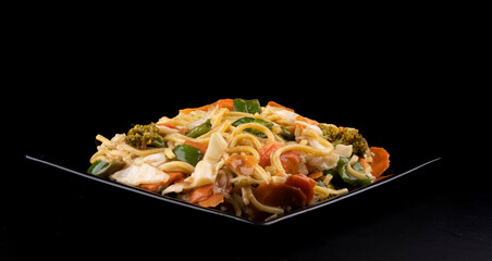 chinese food delivery black plate of yakisoba vegetarian black front portrait