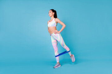 Full body photo of cute korean lady raise leg strength exercise resistance wear stylish sporty look...