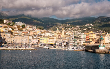 Entrance to the old port and the city of Bastia on the east coast of Corsica with mountains in the distance