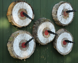 Five throwing knives in target bullseyes