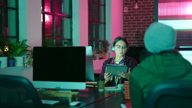 Digital marketing, night and creative with market research on computer planning a startup project with coworker. Teamwork, strategy and young employees working in the dark late for advertising agency