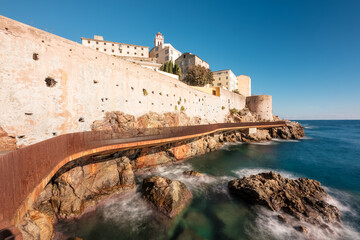 Obraz premium The L'Aldilonda walkway along the rocky east coast and city wall below the citadel of Bastia on the east coast of Corsica