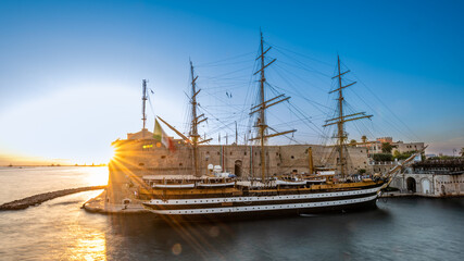 The Italian Navy Historical Ship Called Amerigo Vespucci Moored in front of the Aragonian Castle in the Canalboat of Taranto at Sunset, in the South of Italy