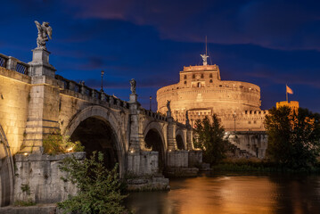 Long Exposition at Blue Hour of The Saint Angel's Castle and a Bridge of the Tevere River Illuminated by Artificial Lights after Sunset