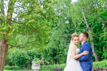 the groom kisses the bride and they close their eyes. walk in th