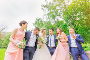 Funny wedding moment of newlyweds and bridesmaids and groomsmen.