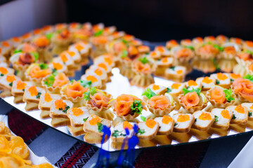 large stand in the shape of a heart with delicious delicacies. r