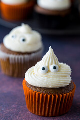 A ghost pumpkin spice cupcake with cute eyeballs.