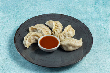 Steamed chicken mom wrap with ketchup served in a dish isolated on background top view