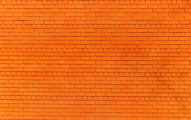 a brick wall painted orange as a background or texture