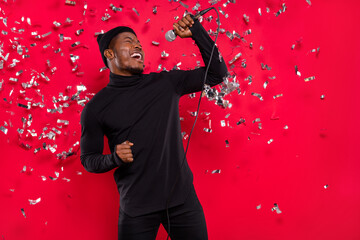 Photo of dreamy funny young guy wear black turtleneck headwear enjoying singing songs isolated red color background - obrazy, fototapety, plakaty