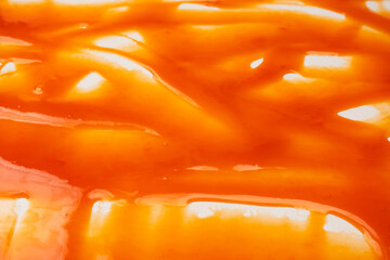 Red sauce splashes as background.