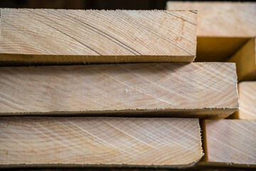 Stacks of lumber on a rack for sale to consumers at a retail hardwood lumber business