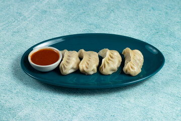 Steamed chicken mom wrap with ketchup served in a dish isolated on background top view