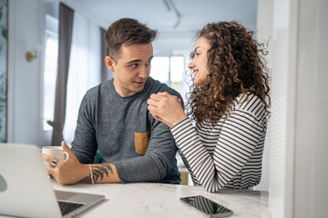 Fototapeta premium happy couple using laptop computer with cup of coffee morning routine