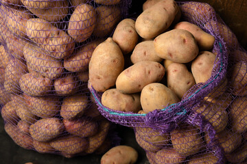 a pile of potatoes on a dark wooden background