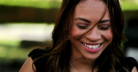 Hispanic woman laughing and smiling spontaneous laughter