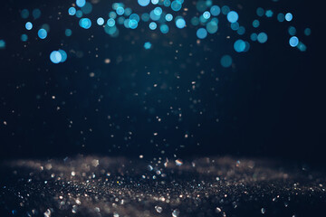 Glowing in the dark defocused glitter texture with blue bokeh lights and snow. Christmas and winter...